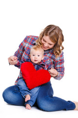 Happy mother and her child holding a red heart