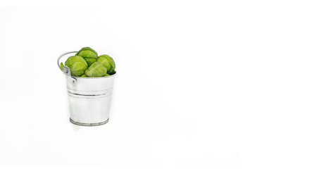 Fresh Brussels Sprouts in a Bucket on a White