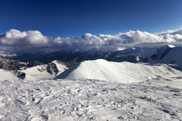 View on off-piste slope and snowy mountains