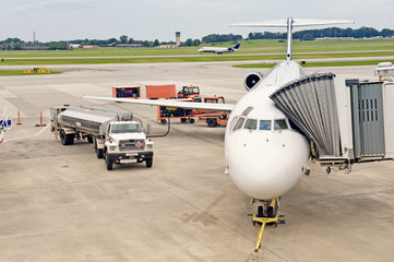 Airliner Being Serviced Between Flights While Another Lands