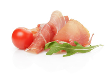 slice of italian prosciutto with arugula leaf and tomato