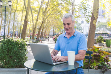 American Senior Man with Computer at Park