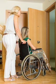 Woman helping handicapped girl
