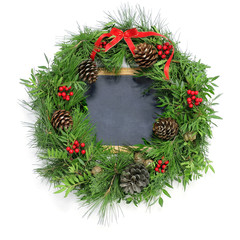 Fototapeta na wymiar christmas wreath and a blank chalkboard