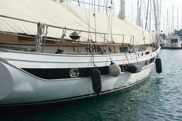 Fototapeta premium sailing yacht with canvas cover in marina