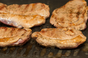 steaks grilling in a pan
