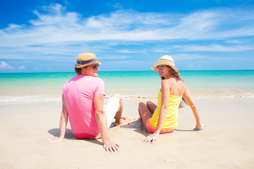 Couple walking and having fun on a tropical beach at Maldives