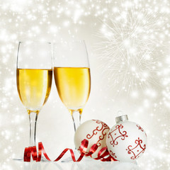 Champagne and Christmas decorations against holiday lights