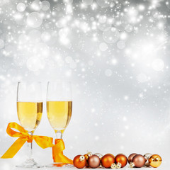 Champagne and Christmas decorations against holiday lights