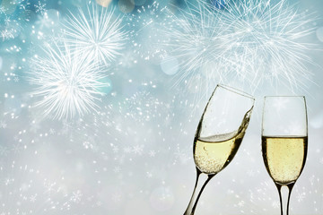 Glasses with champagne against fireworks