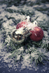 Red christmas baubles on the snow. christmas decorations