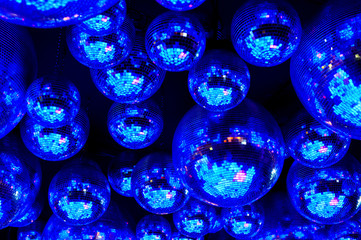 Blue nightclub disco balls in festive lights in dance club