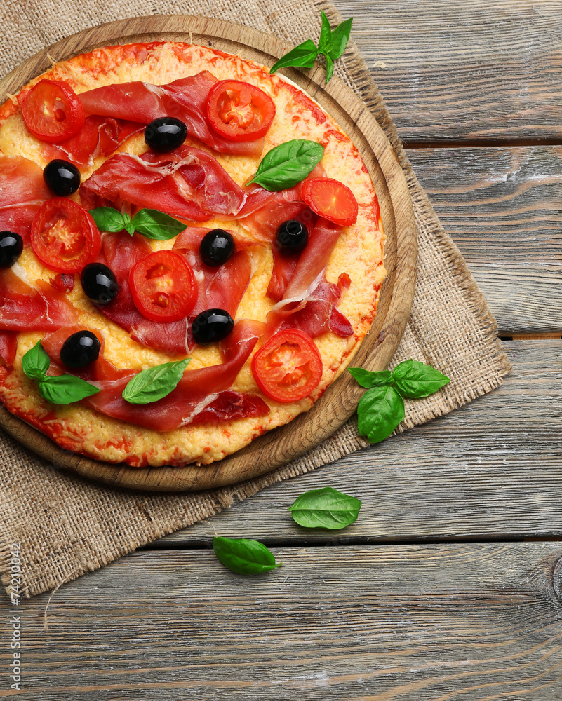 Wall mural Delicious pizza served on wooden table