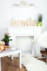 Fireplace with beautiful decorations in comfortable living room