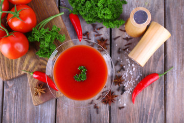 Tomato juice in goblet and fresh vegetables