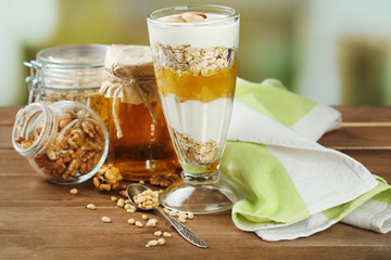 Tasty dessert with oat flakes and honey, on table