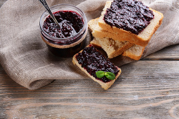 Delicious black currant jam on table close-up