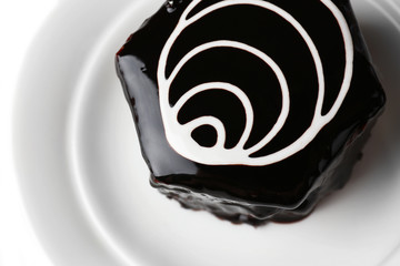 Yummy chocolate cupcake on plate close-up