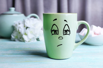 Emotional cup on wooden table