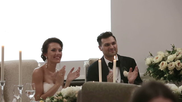 Newlyweds at the wedding sitting at the table at bridal