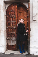 Fototapeta na wymiar young woman opens the door of the church