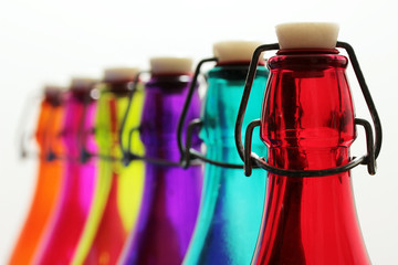 Row of blurred colored bottles