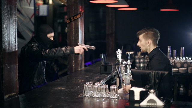 The robber breaks into a bar and takes the money