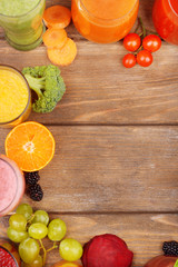 Glasses of tasty fresh juice, on wooden table.