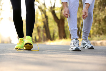 Runner feet on road, outdoors