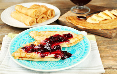 Delicious pancakes with berry jam  and bananas