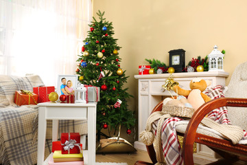 Beautiful Christmas interior with decorative fireplace and fir