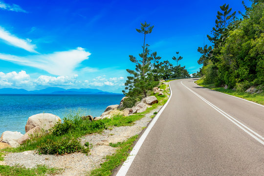 Curving road along sea in Magnetic Island, Australia