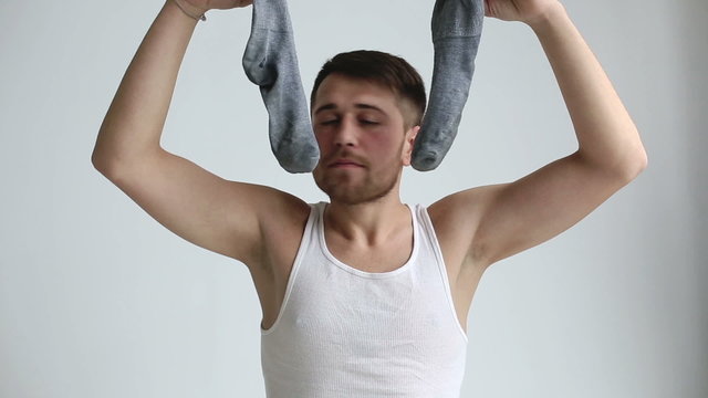 Man is smelling his socks