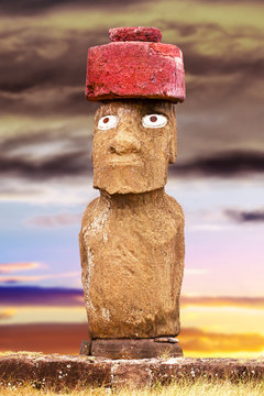Standing moai with red stone hat and eyes in Easter Island, Chil