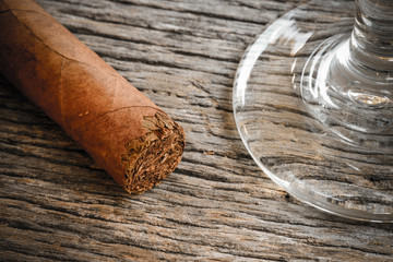 Cigar with Glass of Brandy or Whiskey on Wooden Background