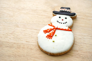 Snowman Cookie on Wood Background