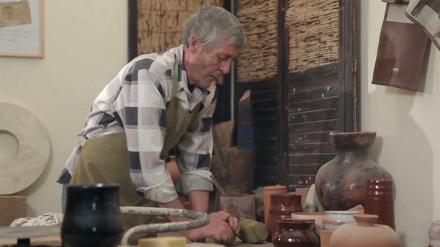 Master preparing his molding his clay