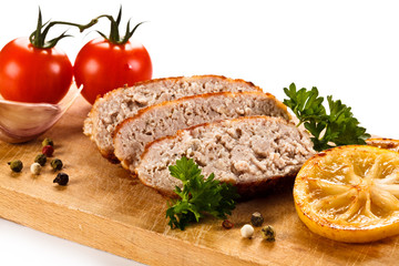 Fried chops and vegetables on cutting board
