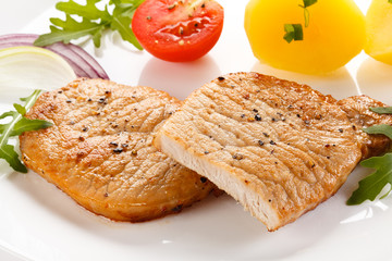 Fried steaks, boiled potatoes and vegetable salad