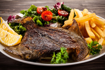 Fish dish - fried flounder, chips and vegetables