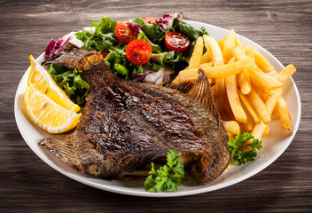 Fish dish - fried flounder, chips and vegetables
