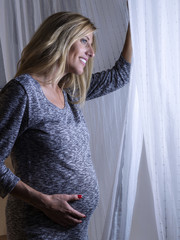 Pregnant Woman Looking Out Window