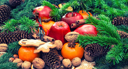 Apples, mandarine fruits, walnuts, cookies and spices