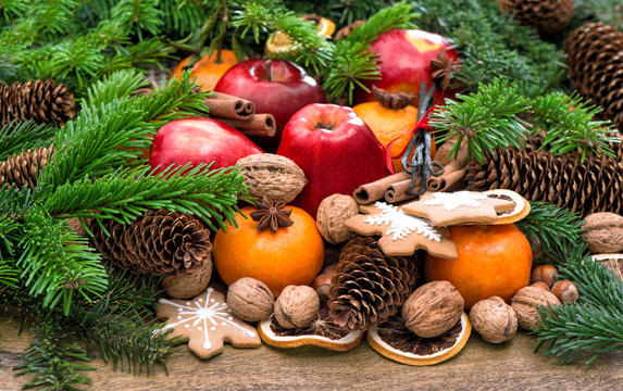 Apples, mandarine fruits, walnuts, cookies and spices