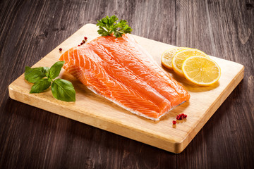 Fresh raw salmon fillet on cutting board