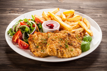 Pork chop, French fries and vegetables