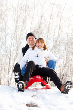 Mature Couple Sledding