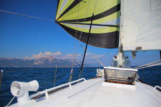sailing race along the mountainous coast