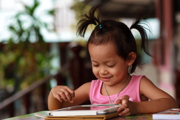 Happy child staring tablet.