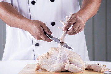 Chef prepared chopping raw chicken